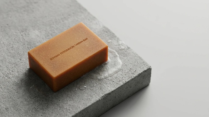 Persimmon tannin soap bar on concrete slab